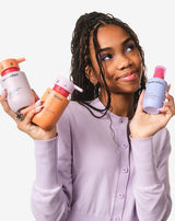 Model with shampoo, conditioner, and detangling spray,